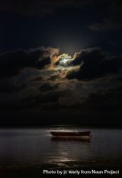 Full moon on cloud night above an ocean with a boat 5ooX85