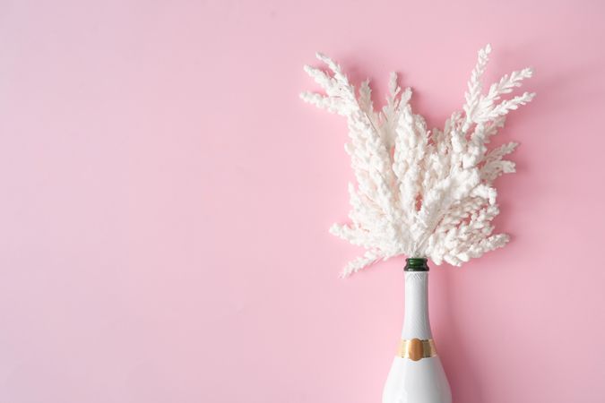 Champagne bottle with snowy Christmas decoration