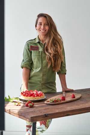 Smiling woman with plate of strawberry cake