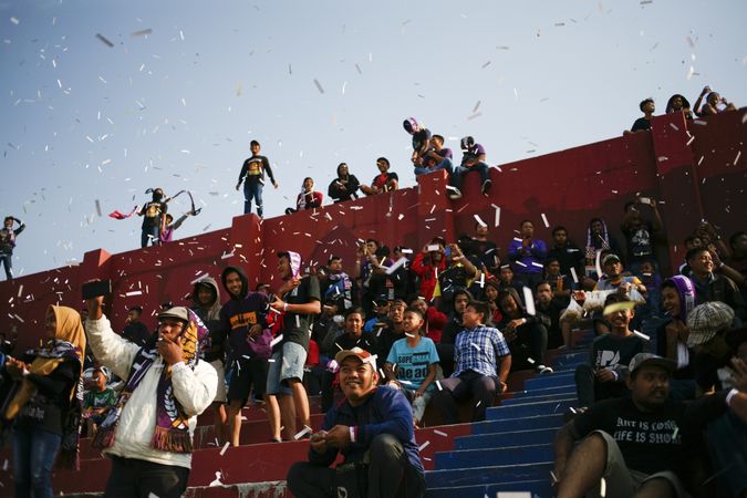 Kedira, East Java Indonesia - October 4, 2019:  Fans standing and sitting at soccer game