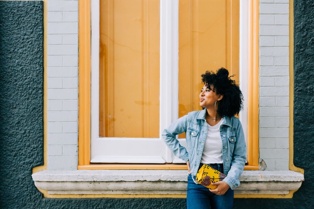 Smiling Black female by yellow window
