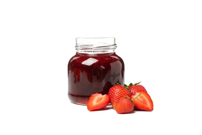 Delicious strawberry jam isolated on blank background