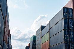 Container boxes stacked for freight cargo shipping looking up to sky