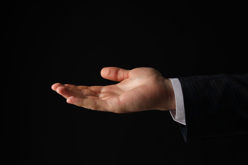 Businessman's hand close-up on a dark background