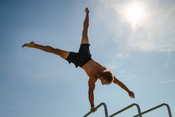 Strong young sportsman doing calisthenics
