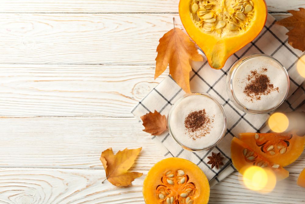 Composition with pumpkin latte on wooden table