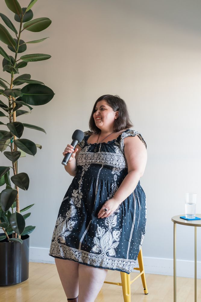 Woman in a dress holding microphone