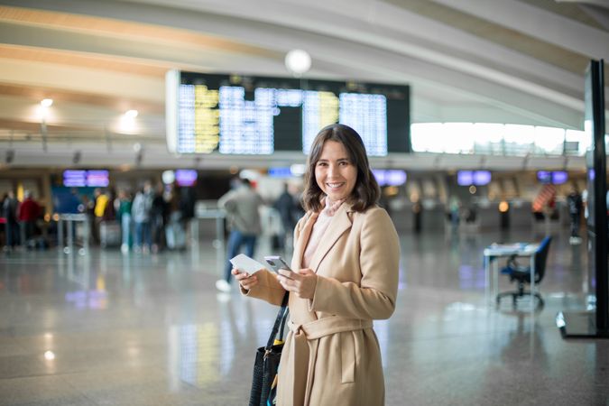 Woman using smartphone at airport