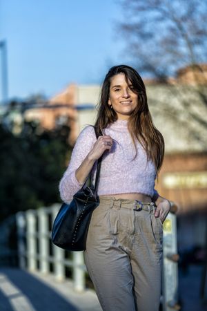 Happy woman in casual wear going for a stroll in the city on a sunny day