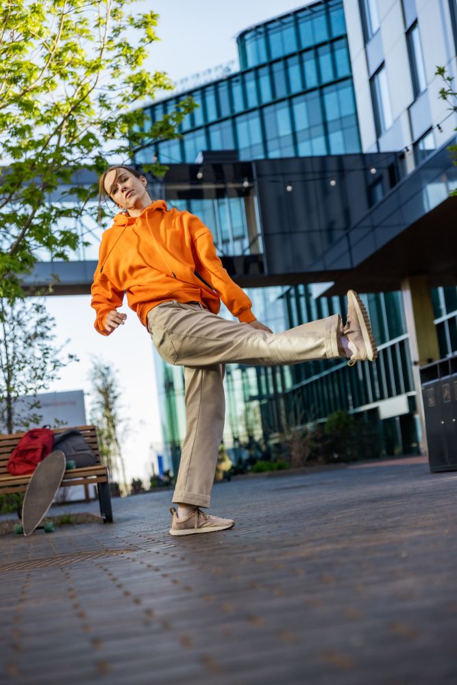 Vertical Screen: Young Female Hip Hop Dancer Freestyling On City Street Among Buildings.