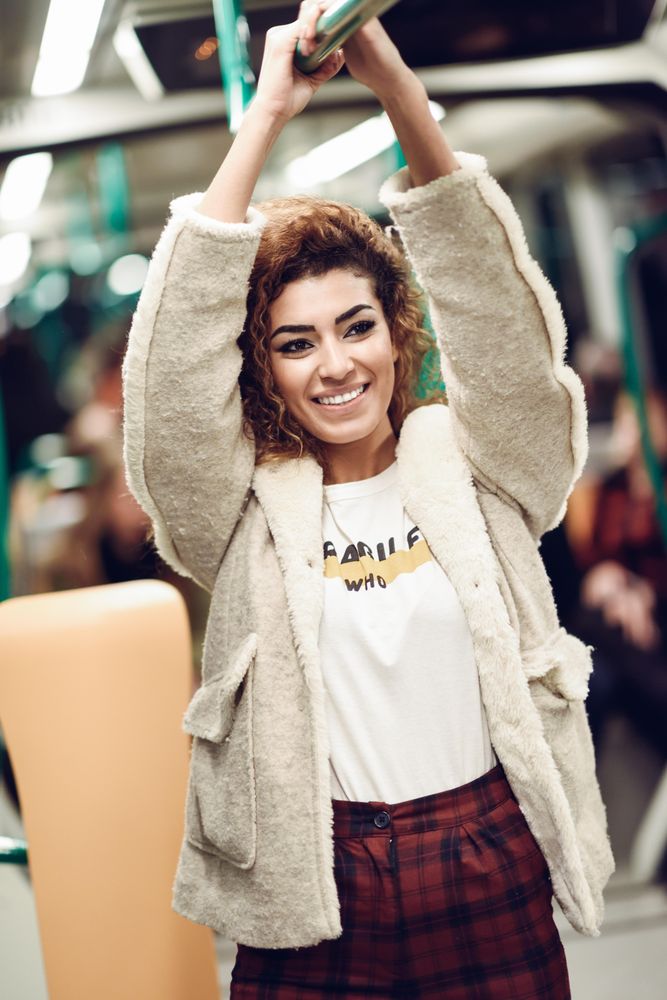 Smiling Arab woman in subway train