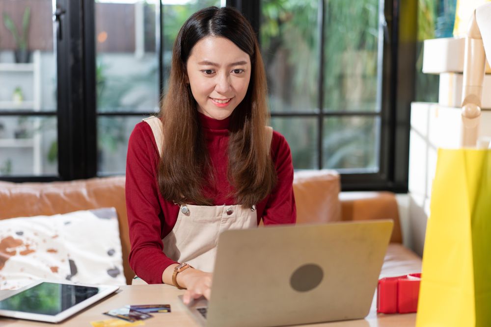 Woman working at online e-commerce store at home
