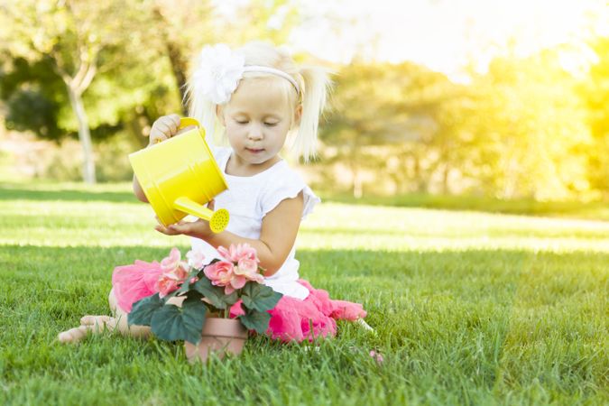 Cute Little Girl Playing Gardener with Her Tools and Flower Pot.