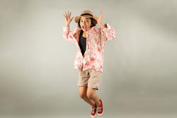 Young Asian Tourist Woman Smiling to the Camera and Jumping, Overjoy About Summer Vacation.