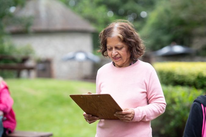 Indian woman with drawing board in park