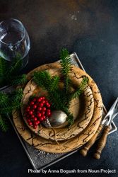 Top view of rustic plates, cutlery and glass with xmas pine and ornament 0K9ZY4