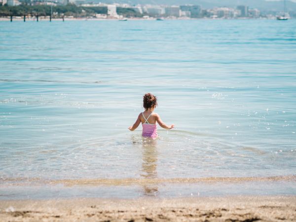 Cheerful girl having fun in warm sea