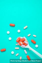Plastic spoon with various colorful pills  4jVRkz