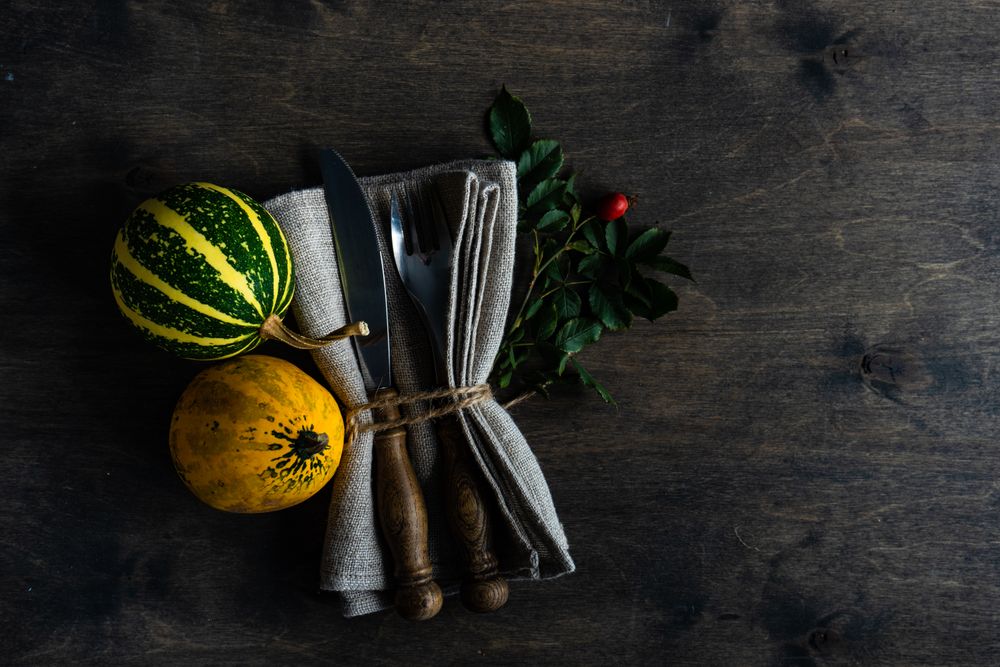Top view of table with mini squashes and cutlery