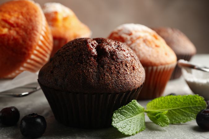 Composition with delicious muffins on gray background