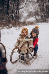 Two children in snow slide 4dknD5