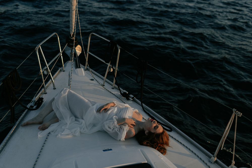 Woman in luxury dress resting on yacht