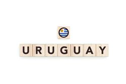 Wooden blocks bearing the name and flag of Uruguay. Uruguayan and South American Culture, national identity, travel, and geography in a copy space design.