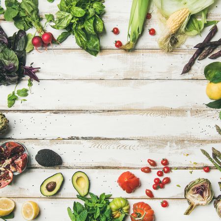 Assortment of seasonal vegetables on painted wooden table with copy space