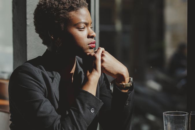 Smiling stylish Black woman in cafe