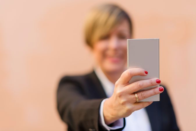 Female holding phone with selective focus