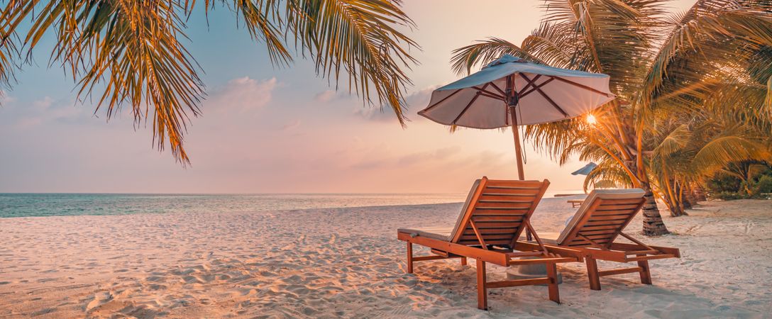 Wide shot of quiet spot on the beach to relax with sunflare