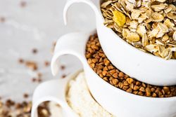 Close up of ceramic bowls full of different grains