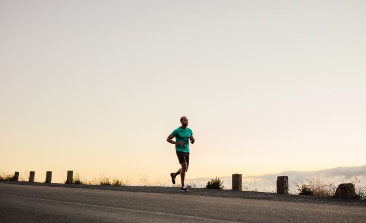 Athlete running on empty road in the morning