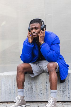 Black man listening to music in city