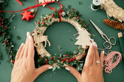 Crop hand of unrecognizable woman with decorative Christmas decorations