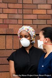 Two women friend nurses on break outside together 5Xr9Vb
