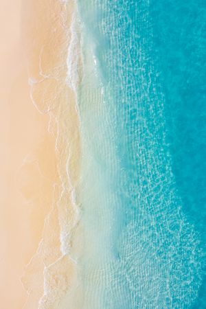 Aerial portrait shot of clear blue ocean waters