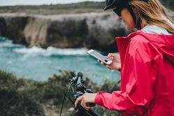Female bicyclist using smartphone