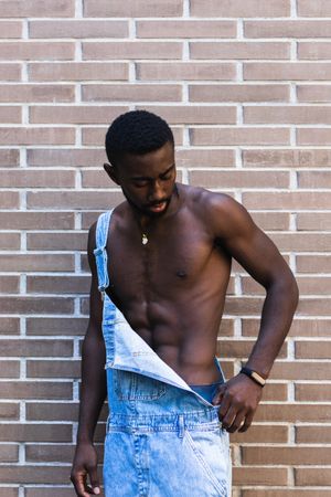 Fit Black man in overalls in city