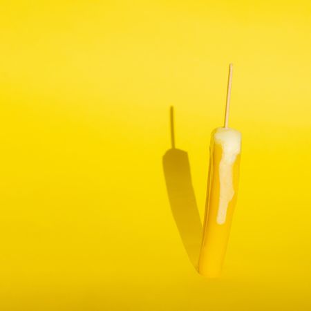 Ice pop on yellow background