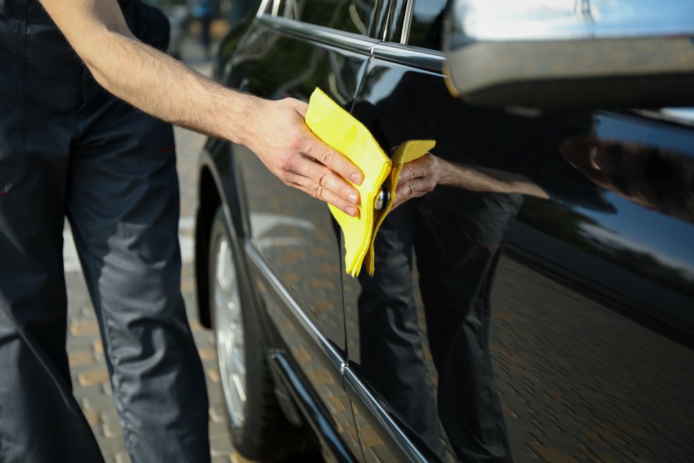 A man rubs a car. Car wash. Clear car concept