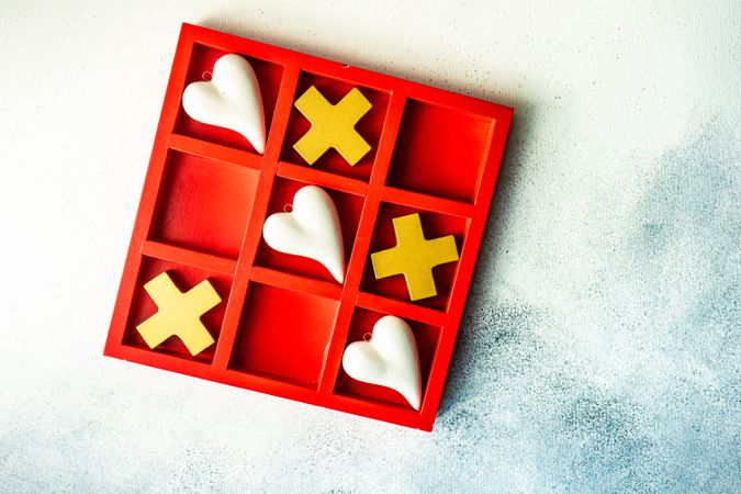 Top view of St. Valentine day card concept with heart in center of tic-tac-toe game