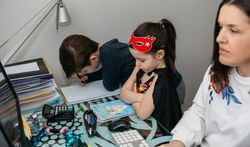 Woman teleworking with her son and angry daughter