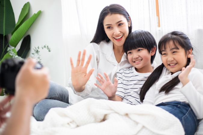 Mother and two children posing for photo