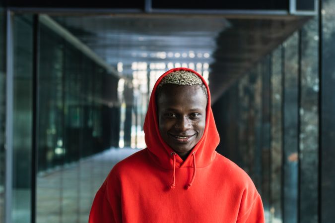 Smiling young Black guy looking at camera in contemporary building