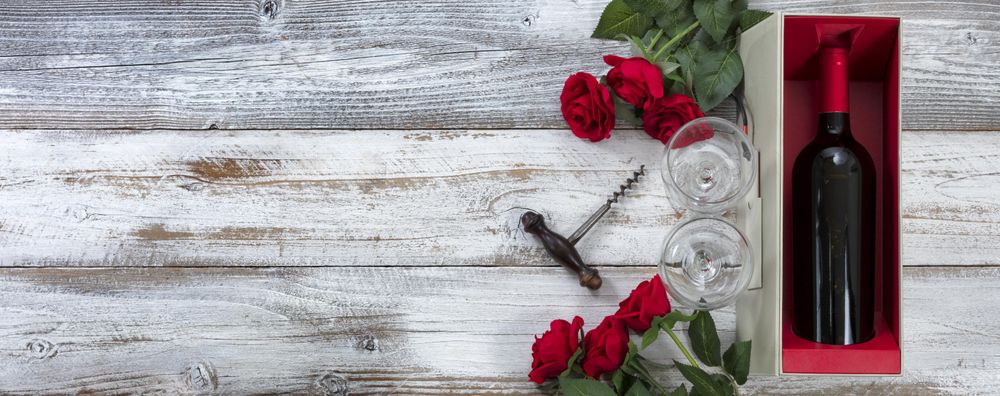 Wine red and roses for a Valentine’s day gift on age wood with copy space