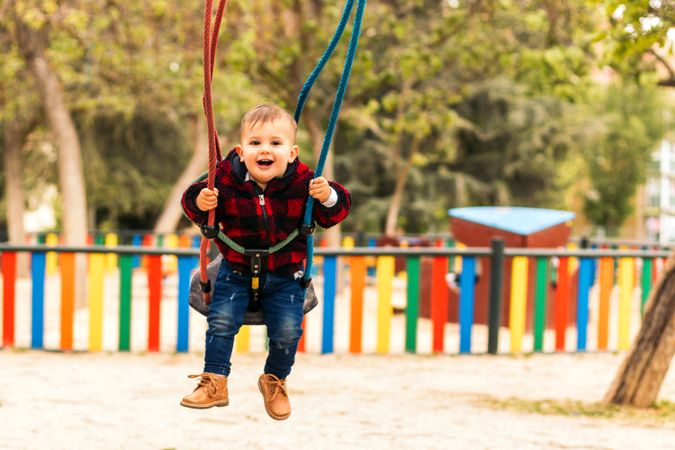 cute baby having fun in a swing