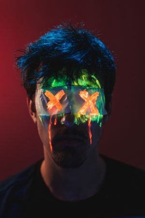Male with covered eyes and neon face