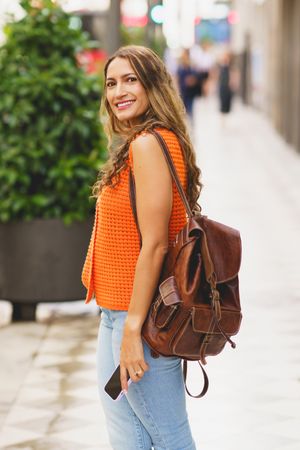 Latina cute woman standing smiling in the city