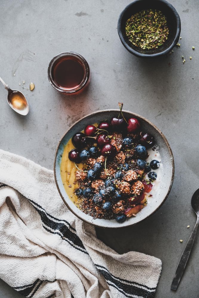 Oat granola yogurt bowl with cherries and blueberries